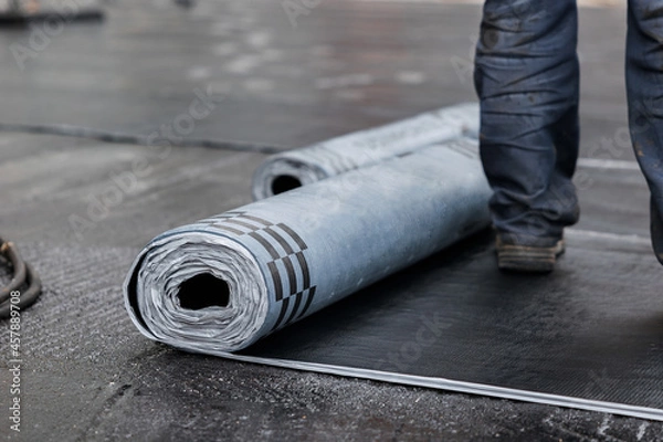 Fototapeta Closeup of Rolls of new black roofing felt or bitumen. Selective focus