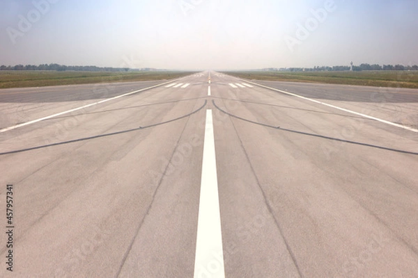 Obraz Runway sign markings and landing lights on the tarmac of runway at a international commercial airport