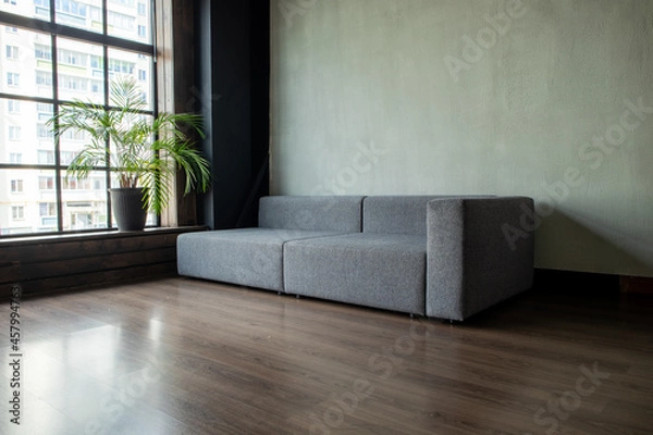 Fototapeta soft upholstered light sofa with modules in the interior with a panoramic window