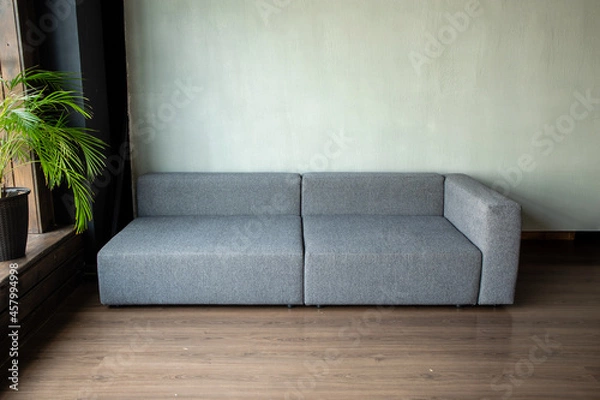 Fototapeta soft upholstered light sofa with modules in the interior with a panoramic window