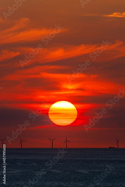 Fototapeta Offshore wind farm in the Baltic Sea in the light of the setting sun with ships