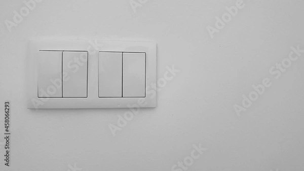 Obraz Two white two-button light switch boxes on a white wall. Minimalist image. Essentials of a house.