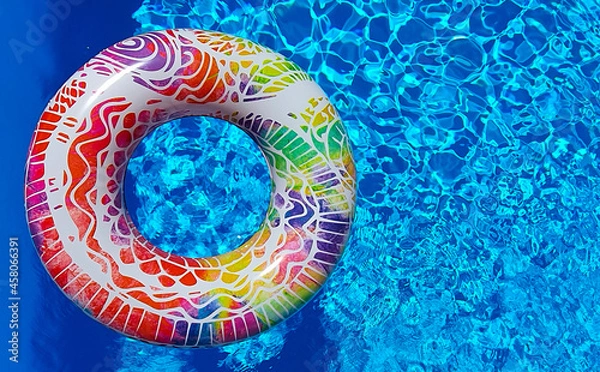 Fototapeta Colored float in a blue pool. Pool float to cool off the hot summer. Summer vibes.