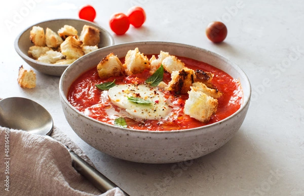 Obraz Bowl of tomato soup with mozzarella and croutons