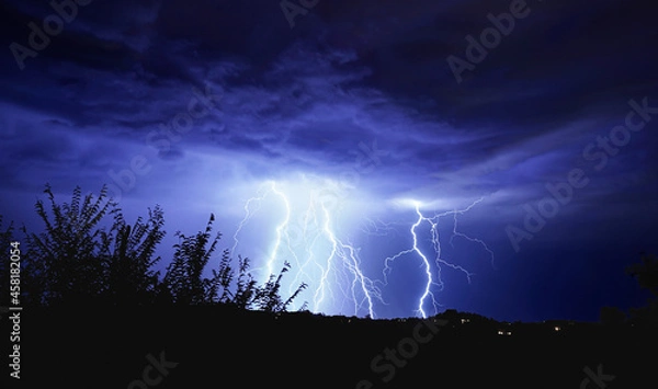 Fototapeta A Monsoon Lightning Storm has numerous strikes, and turns the night blue.