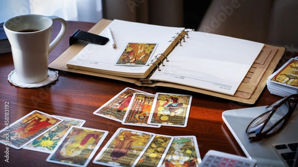 Fototapeta Tarot card reader arranges cards in a card spread. Fortune-telling concept