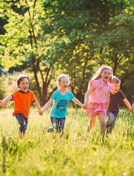 Obraz Large group of kids, friends boys and girls running in the park on sunny summer day in casual clothes .