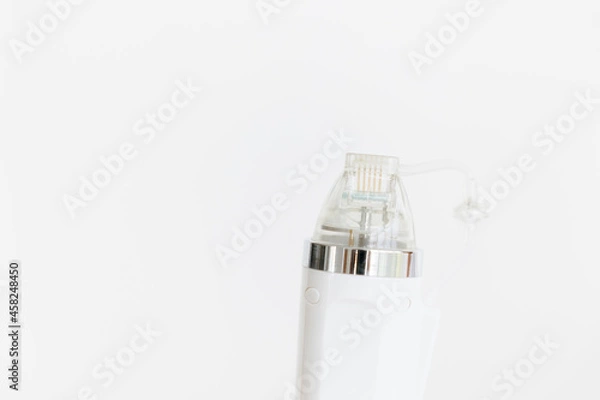 Fototapeta A maniple, a nozzle for a cosmological procedure. Needle rf-lifting. Room, white background. Cosmetology and medical services office. Microneedle radio frequency lifting device. Hardware cosmetology. 