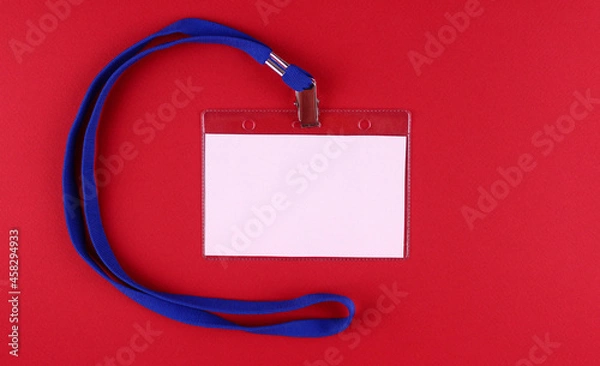 Fototapeta Blank horizontal white badge with blue tie on red background