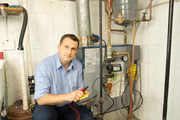 Obraz Plumber repairs furnace