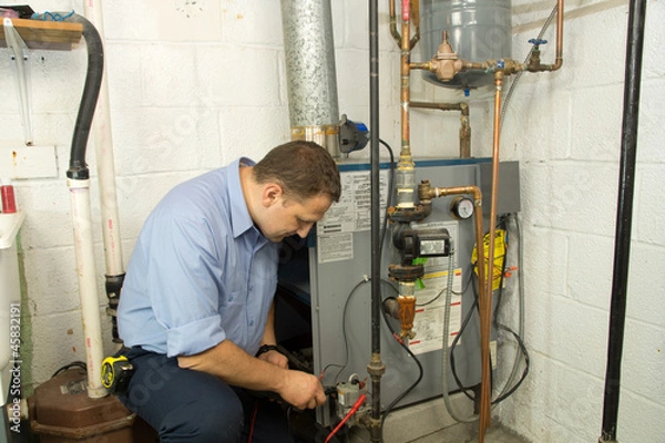 Obraz Plumber repairs furnace