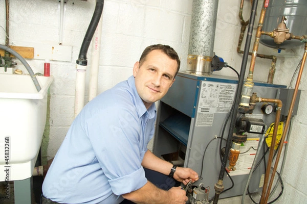 Obraz Plumber repairs furnace