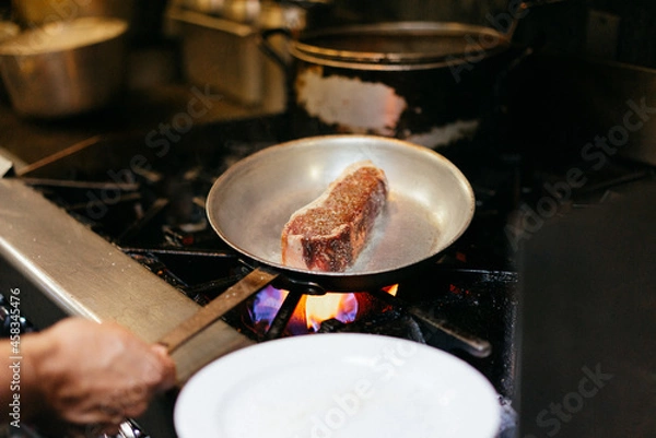 Fototapeta Chef cooking steak