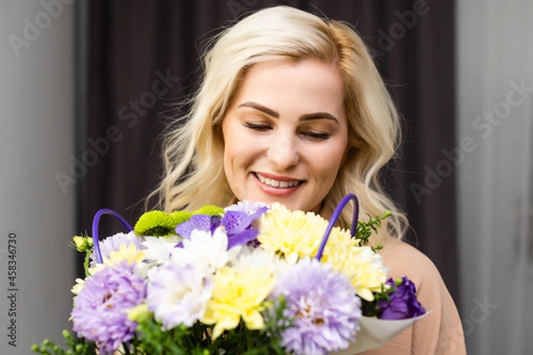 Fototapeta Woman with bouquet of beautiful flowers at home