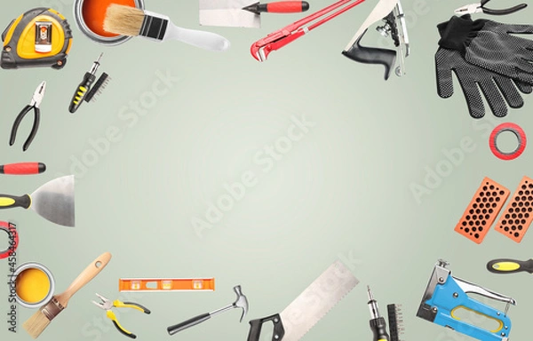 Fototapeta Frame made of different construction tools on grey background