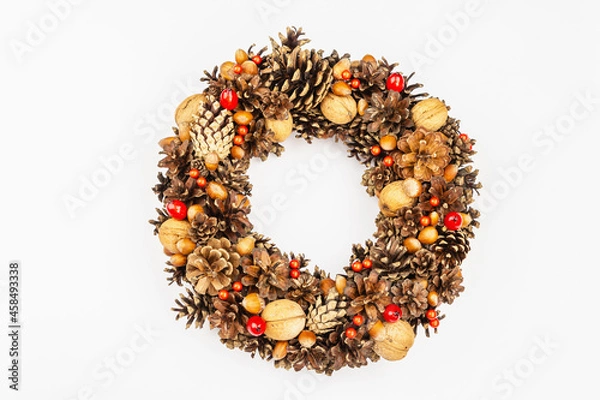 Fototapeta Autumn wreath of cones, nuts, and berries. Creative composition, the handmade