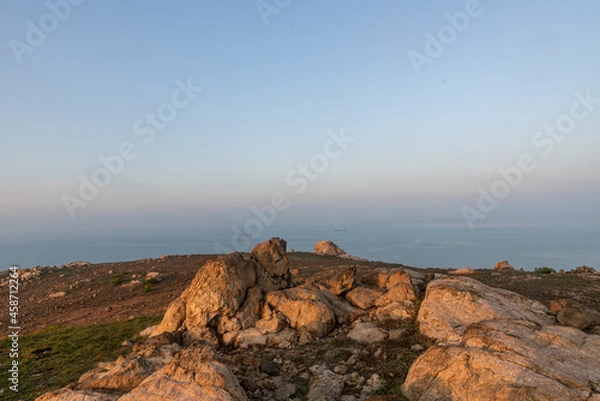Fototapeta The early morning of camping Island, rocks and sunshine form a beautiful scenery
