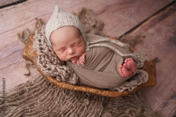 Fototapeta Sleeping newborn boy in the first days of life. Newborn photo session.