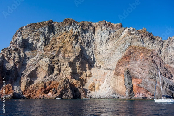Fototapeta Lipari island (Aeolian archipelago), Messina, Sicily, Italy: view of the seacoast with red rocks.
