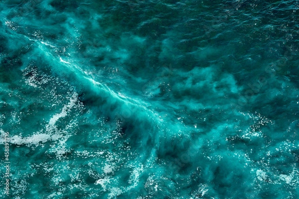 Obraz Aerial view to seething waves with foam. Waves of the sea meet each other during high tide and low tide