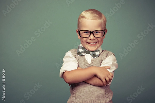 Obraz Cheerful smiling funny boy on a green background.
