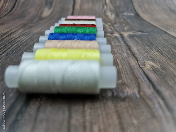 Fototapeta The Multicolored sewing threads. A set of sewing threads.
