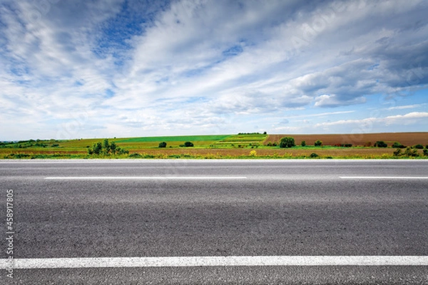 Fototapeta Country road with field on horizon. Side view