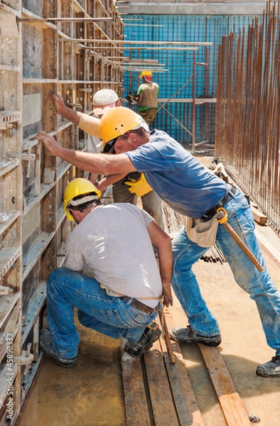 Obraz Construction builders positioning concrete formwork frames