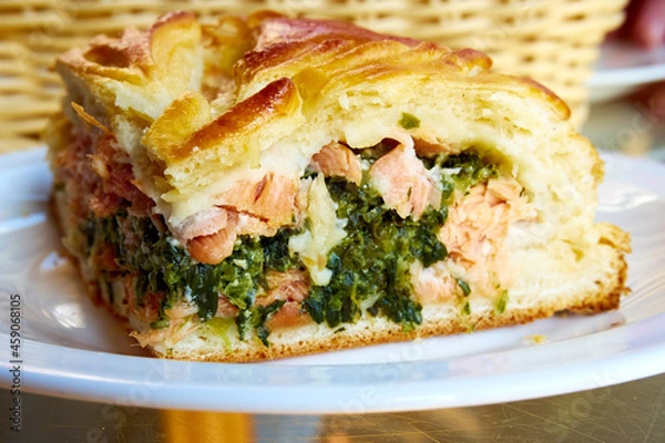 Fototapeta Pie with red fish and spinach close-up