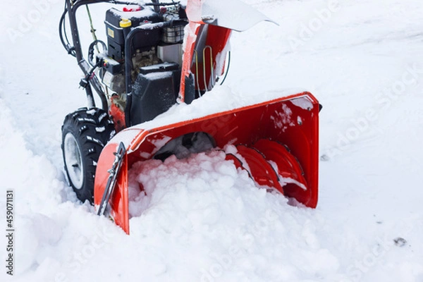 Fototapeta A snow thrower is the best assistant for snow removal in the winter.snow removal with snowplow.abnormal amount of snow