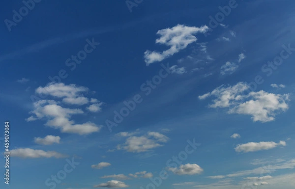 Fototapeta Bright blue sky with small clouds