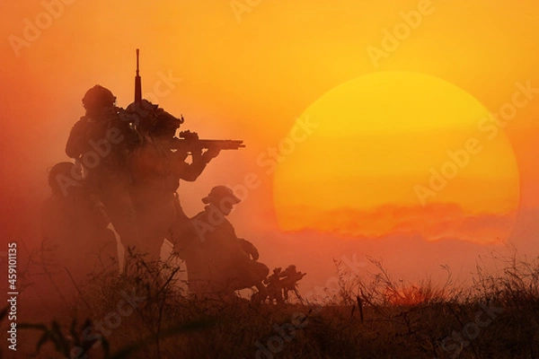 Fototapeta The silhouette of a military soldier with the sun as a Marine Corps for military operations