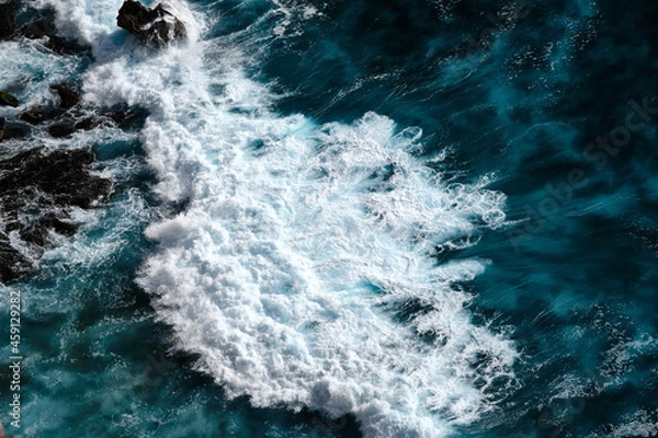 Fototapeta Aerial view to seething waves with foam. Waves of the sea meet each other during high tide and low tide