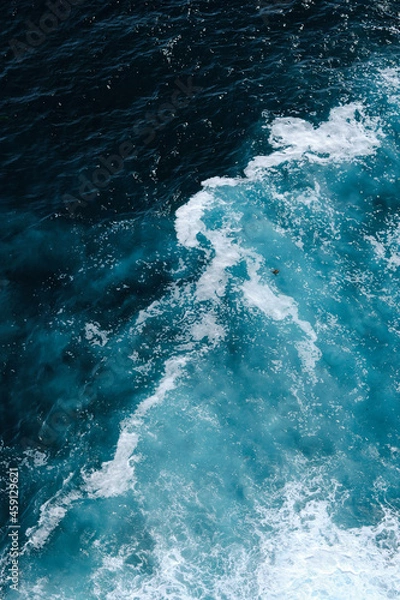 Fototapeta Aerial view to seething waves with foam. Waves of the sea meet each other during high tide and low tide