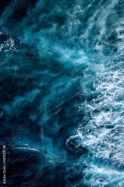 Fototapeta Aerial view to seething waves with foam. Waves of the sea meet each other during high tide and low tide