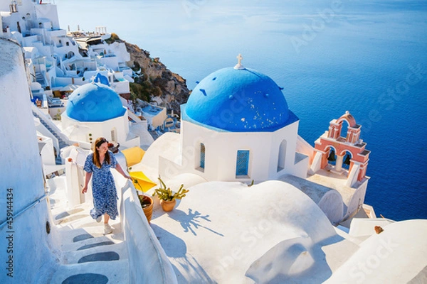 Fototapeta Beautiful girl in Oia village on Santorini island