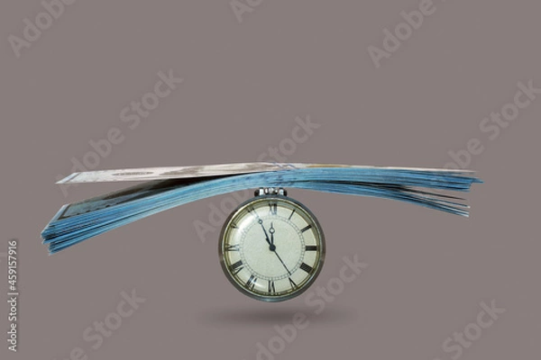 Obraz the hours and money isolated on a gray background,concept, do not waste time for which it is possible to earn money as loss of time is equivalent 