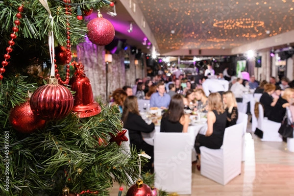 Obraz Close up of decorated christmas tree in the restaurant. New Year's corporate event of a large company. Blurred background, selective focus.