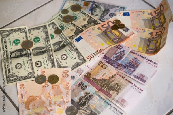 Fototapeta banknotes of Turkish lira, euro, rubles and dollars of different denominations with coins