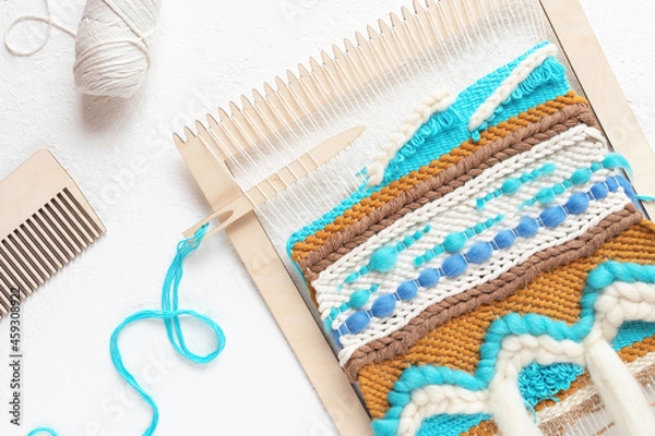 Obraz Handmade wall hanging weaving process on white background.