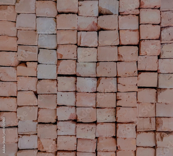 Fototapeta A stacked grid of red bricks of indian origin used in construction of buildings or walls