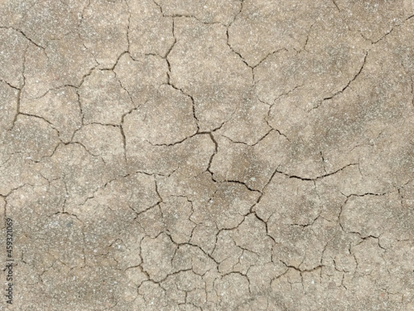 Fototapeta A close up shot of droughty sand mud during harsh summers with cracks in the soil 