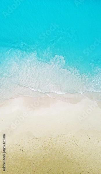 Fototapeta Top view of the beautiful ocean shore with waves and foam on the sand. Seychelles. Texture and background tourism design