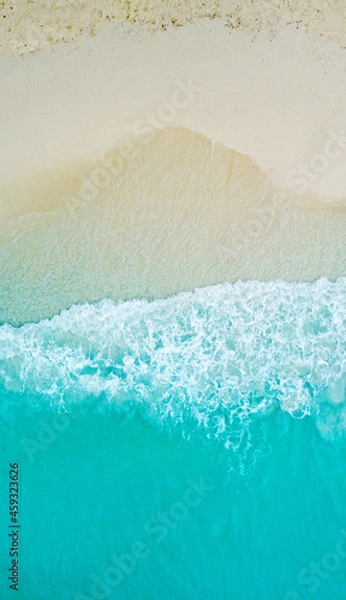 Fototapeta Top view of the beautiful ocean shore with waves and foam on the sand. Seychelles. Texture and background tourism design