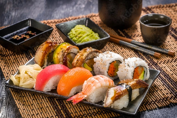 Fototapeta Assorted Sushi on Bamboo Mat with Saki