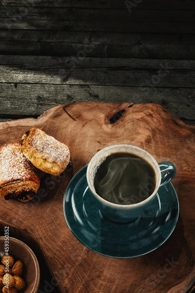 Fototapeta Hot Coffee in Rustic Cup with Pastry on Wood Surface with Room for Copy