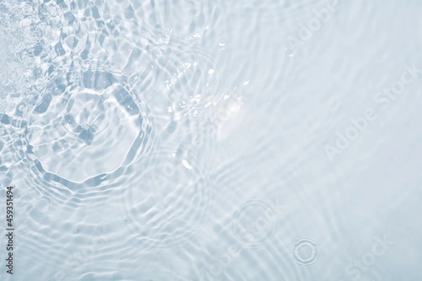 Fototapeta Light blue water background with circles from drops and stains all over the surface