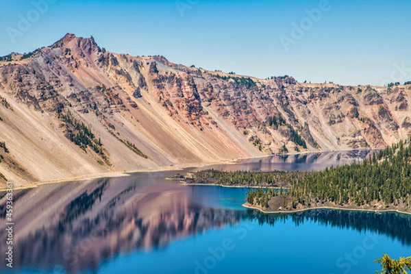 Obraz Blue lake in the mountains with large volcanic cinder cone island.