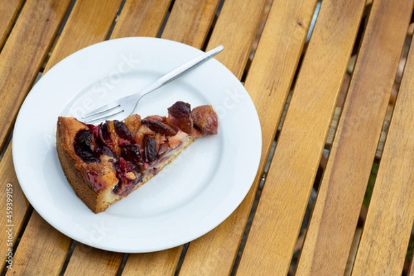 Obraz Plum cake on a wooden table with copy space