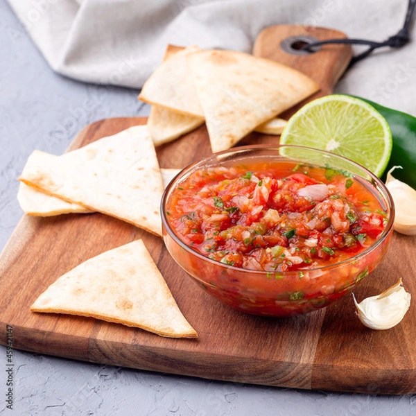Obraz Tex-Mex cuisine, salsa Asada sauce with tortilla chips and lime, square